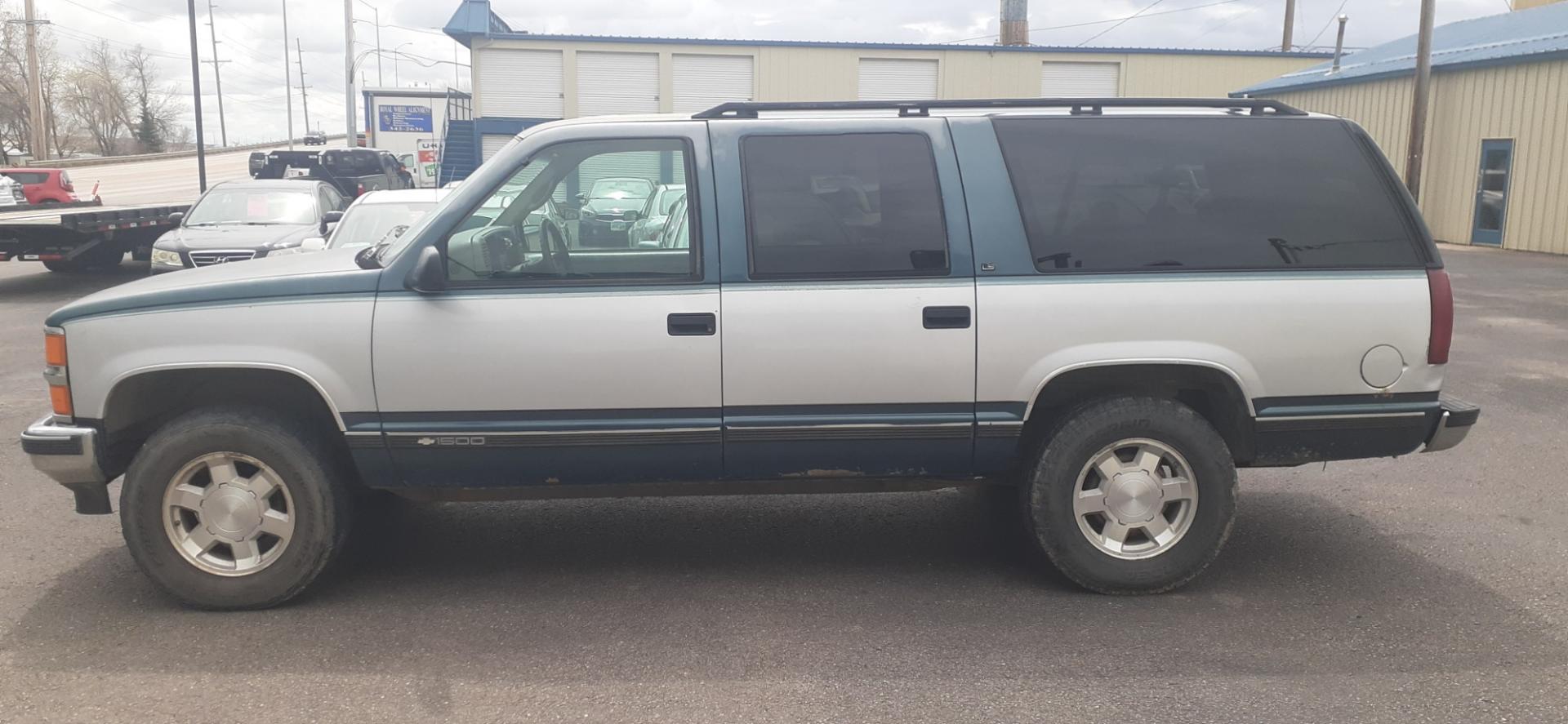 1995 Chevrolet Suburban K1500 4WD (1GNFK16K8SJ) with an 5.7L V8 OHV 16V engine, 4-Speed Automatic Overdrive transmission, located at 2015 Cambell Street, Rapid City, SD, 57701, (605) 342-8326, 44.066433, -103.191772 - CARFAX AVAILABLE - Photo#0